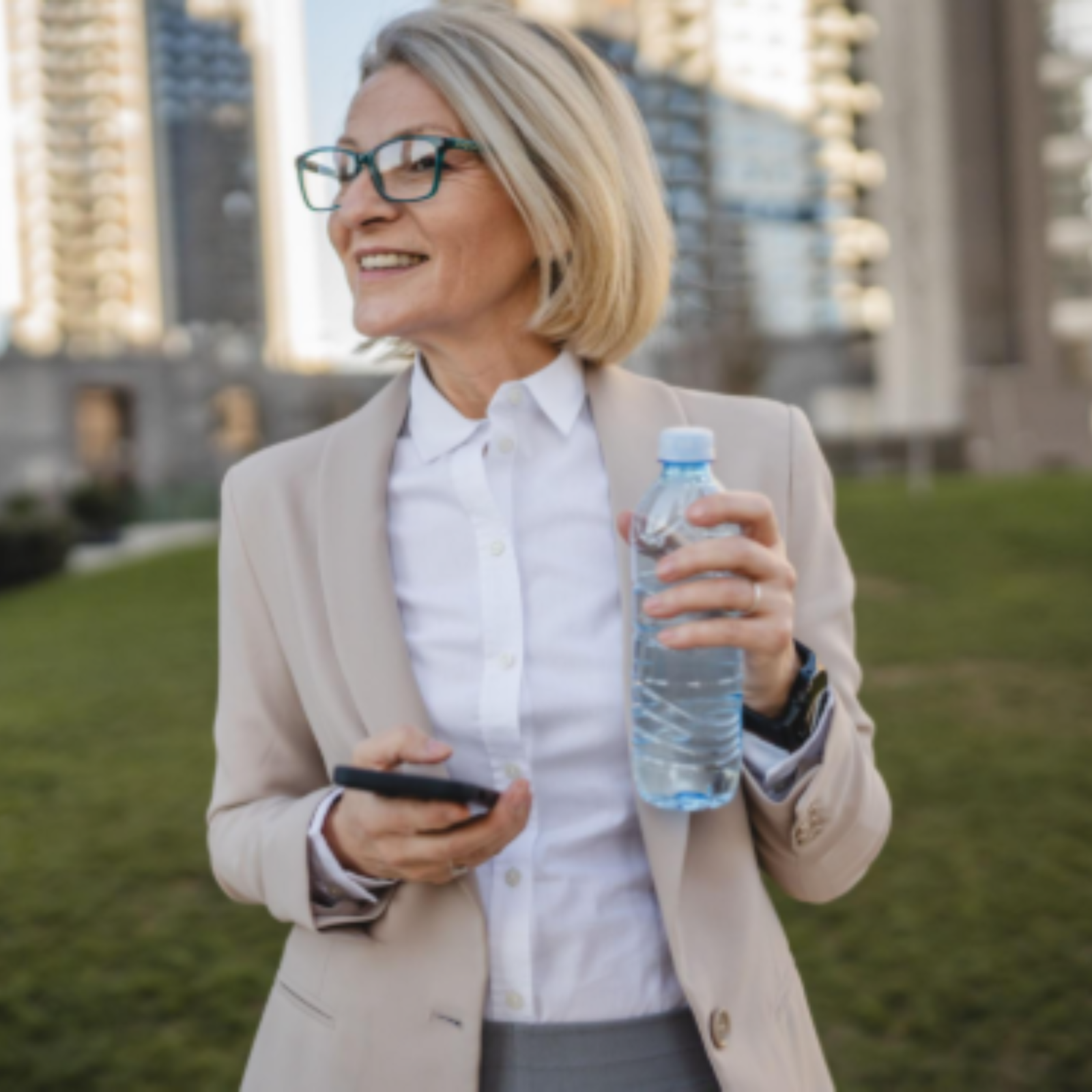 Older professional woman outdoors carrying water